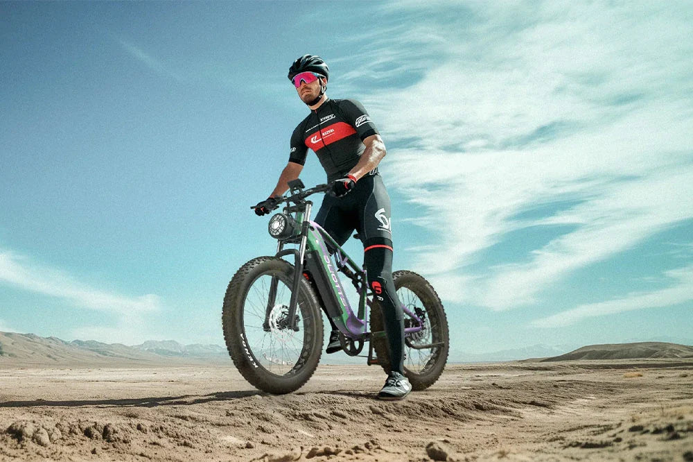 High-performance off-road electric bicycle displayed by rider in racing gear on sandy desert plain